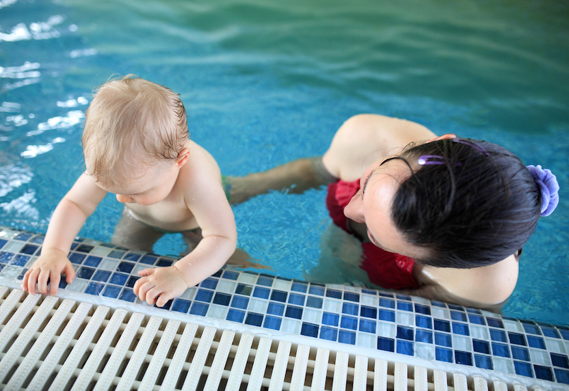 Woman with baby in pool